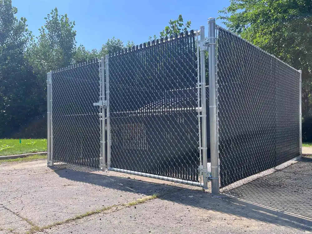 Commercial chain link fence with a wide gate at a business property